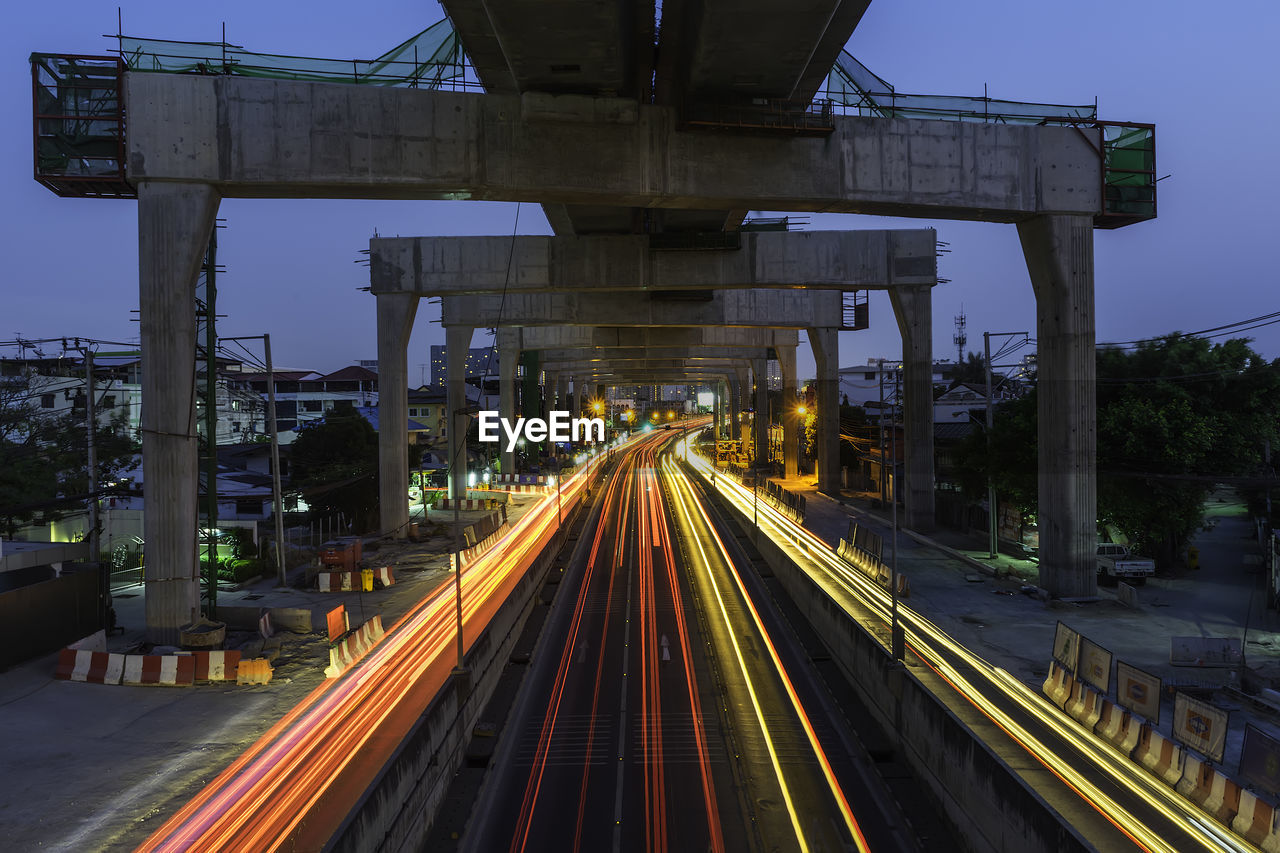 LIGHT TRAILS ON ROAD AT NIGHT