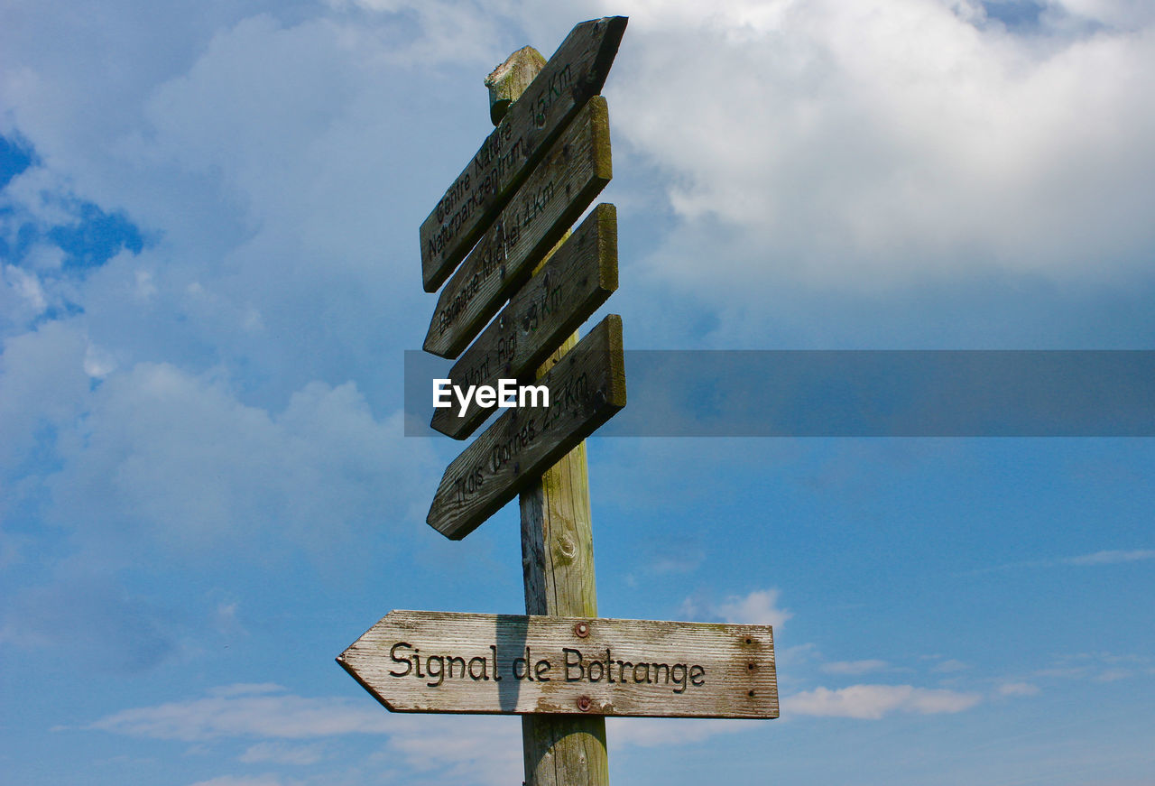 LOW ANGLE VIEW OF SIGN AGAINST SKY