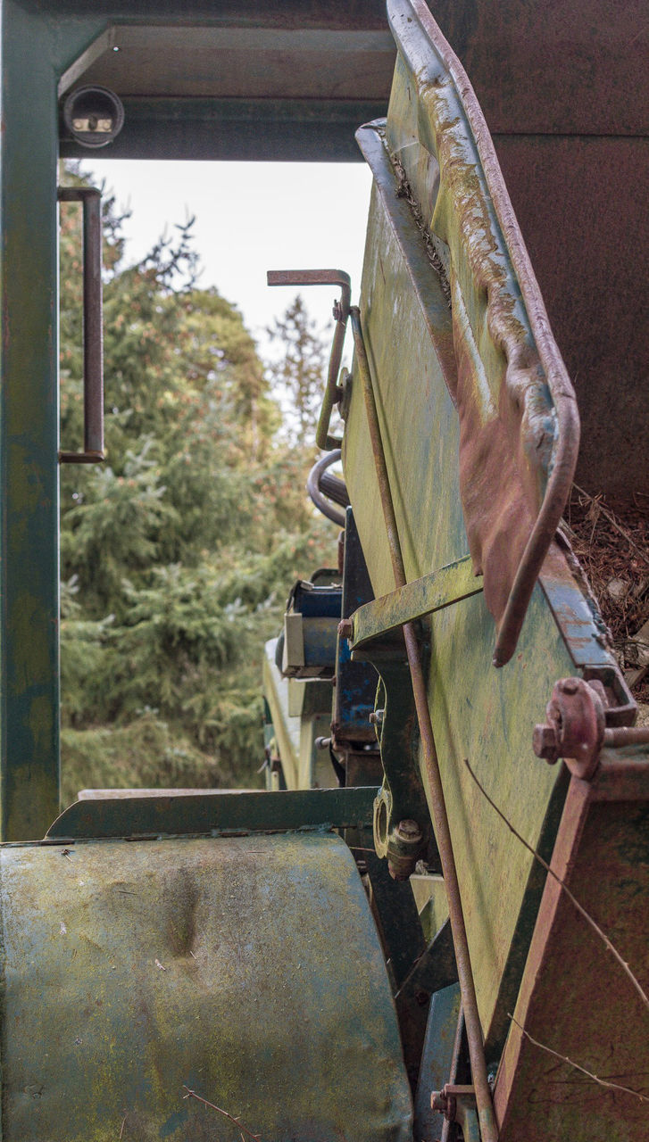 OLD ABANDONED CAR ON METAL STRUCTURE