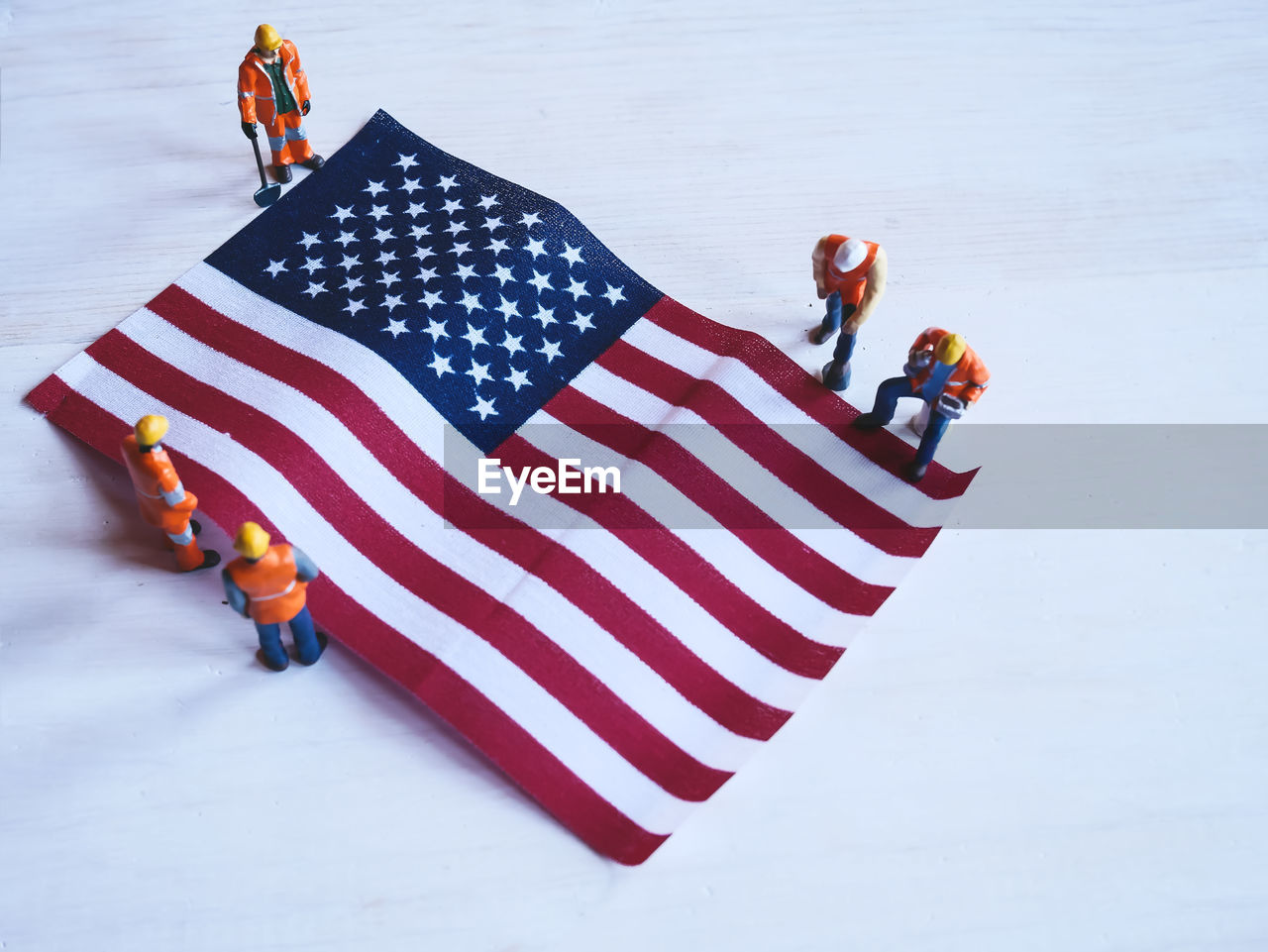 HIGH ANGLE VIEW OF PEOPLE WITH FLAG ON UMBRELLA