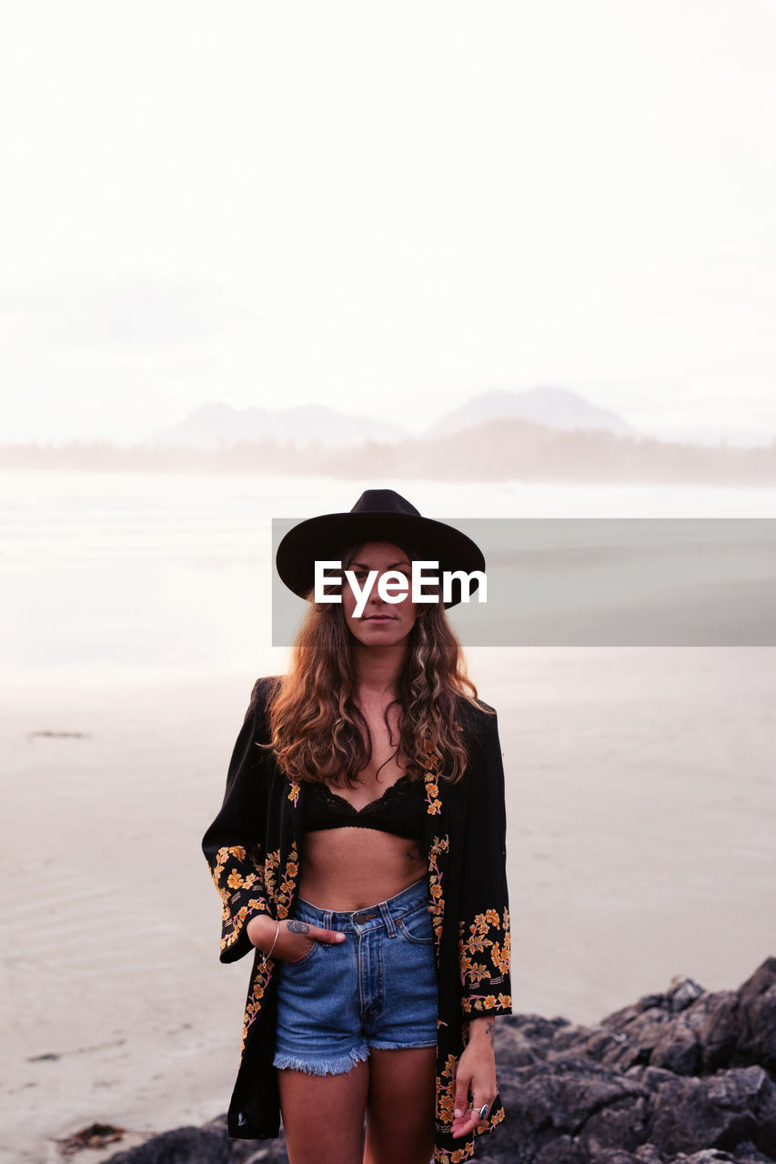 Beautiful, stylish woman on cox bay beach in tofino