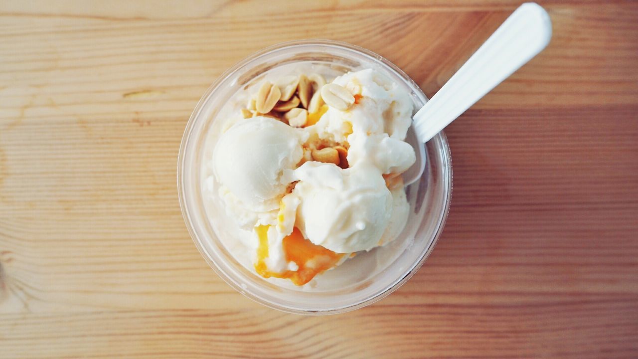 Directly above shot of ice cream in cup on table