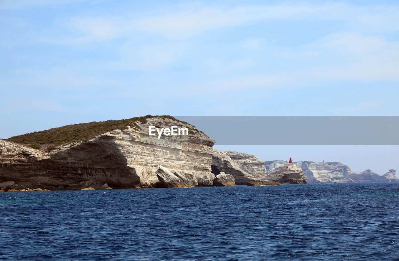 Scenic view of sea and rocks against sky