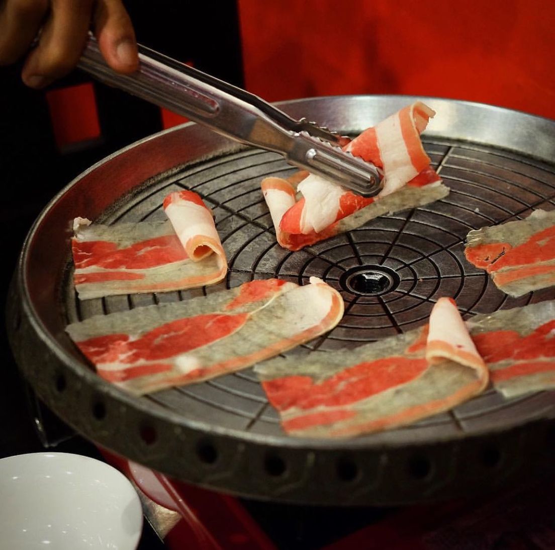 CLOSE-UP OF PERSON PREPARING MEAT