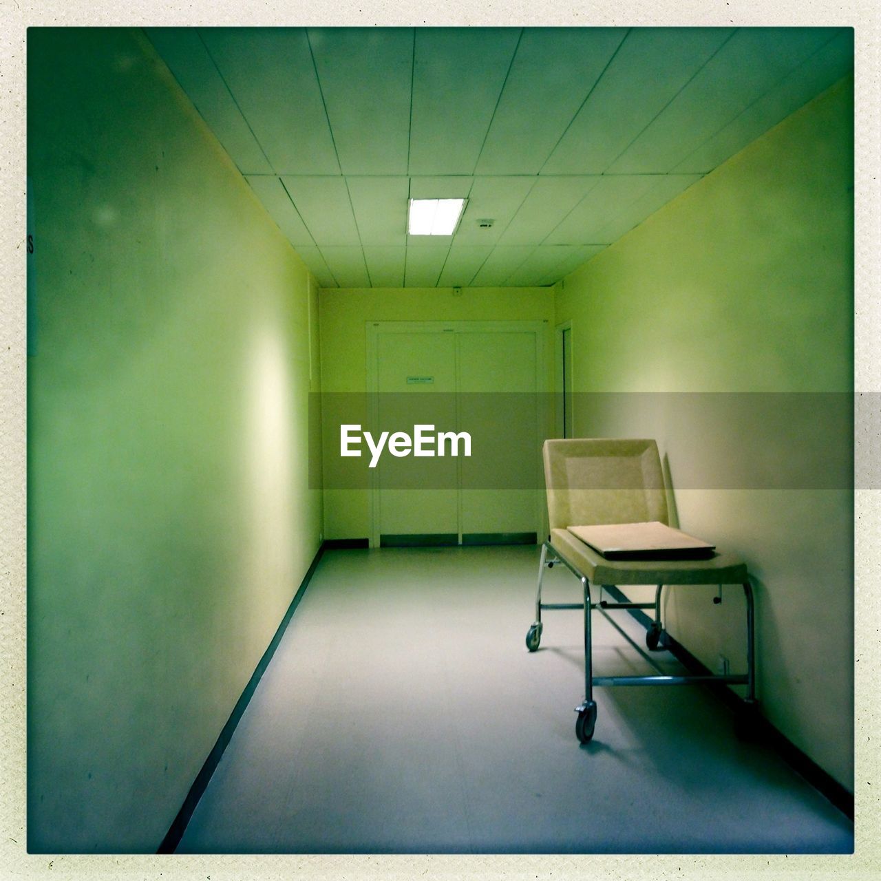 Empty hospital corridor with stretcher bed