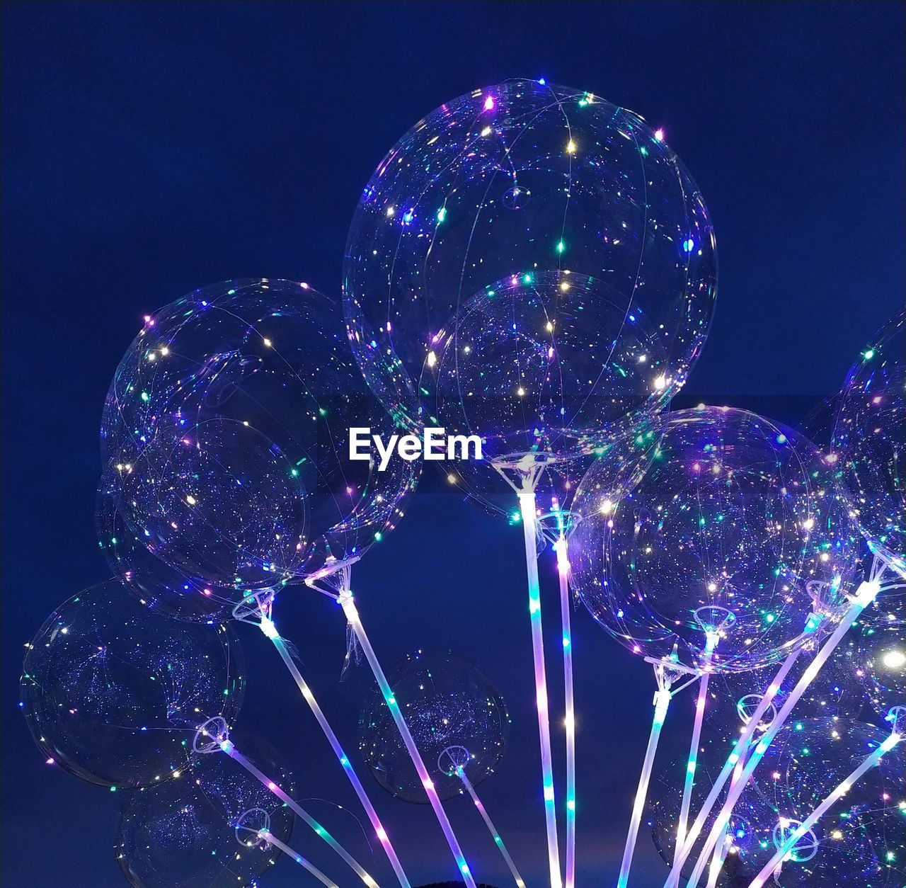 Low angle view of illuminated ferris wheel at night