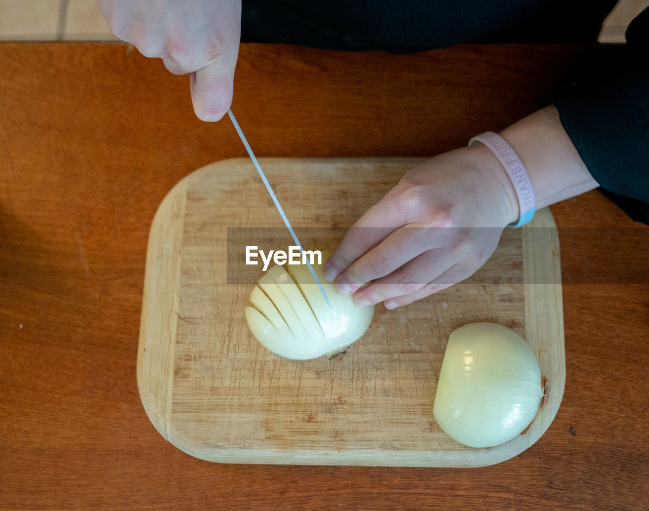 HIGH ANGLE VIEW OF PERSON PREPARING FOOD