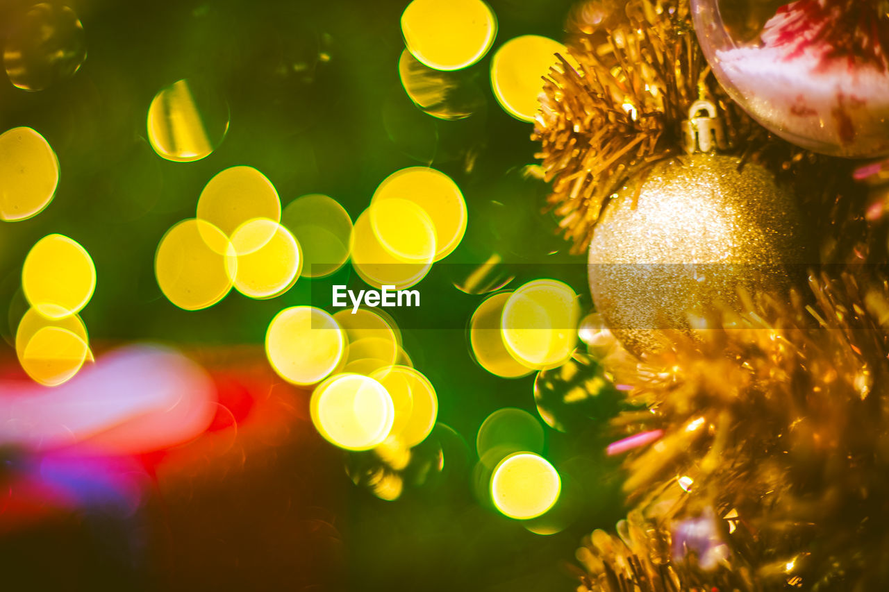 Christmas ball decoration on yellow background. colorful blur bokeh background. christmas background