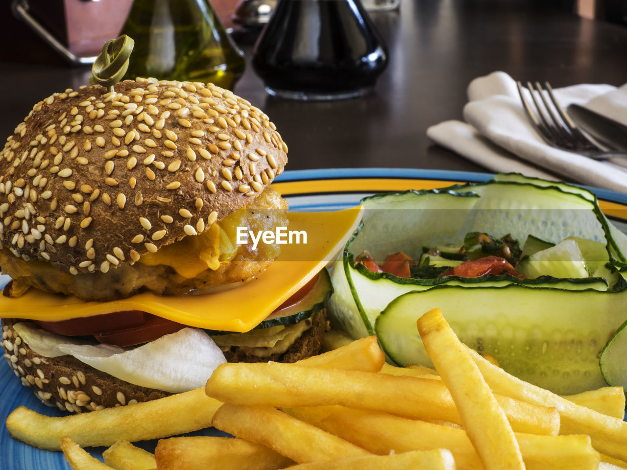 Close-up of cheeseburger with french fries in plate