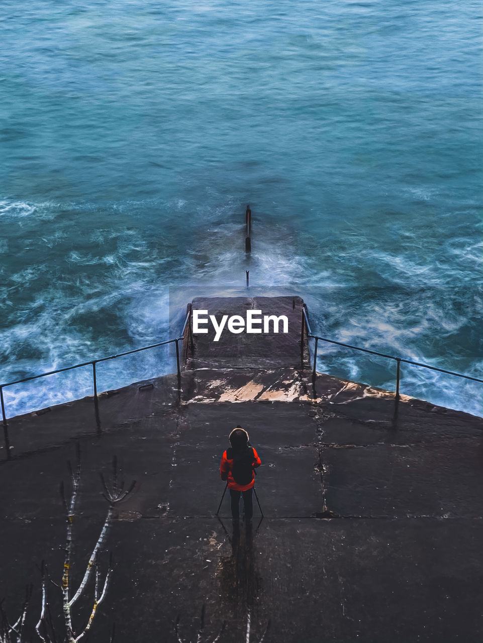 High angle view of man standing infront of sea