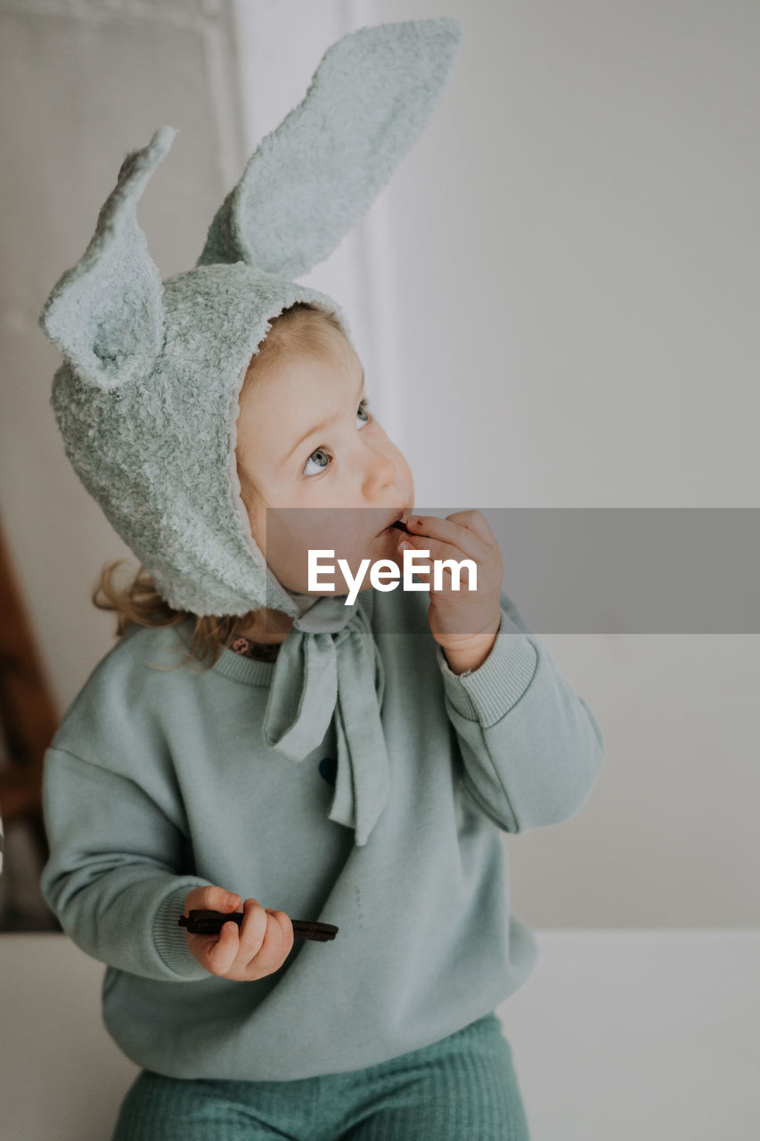 Toddler baby girl in funny hat with ears having fun