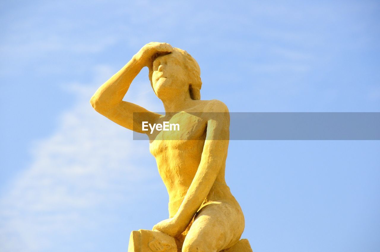 Low angle view of statue against sky