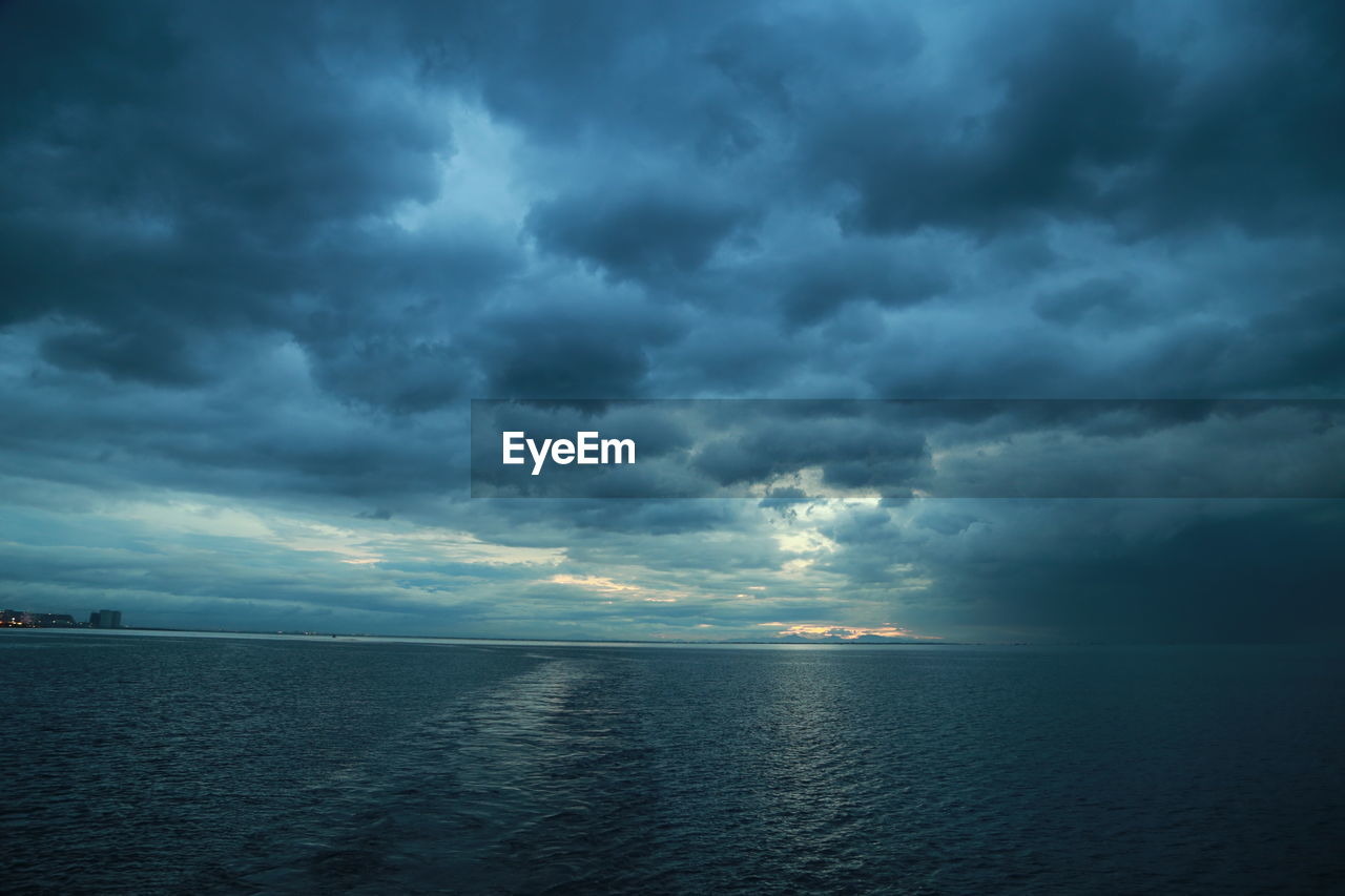 Scenic view of sea against storm clouds