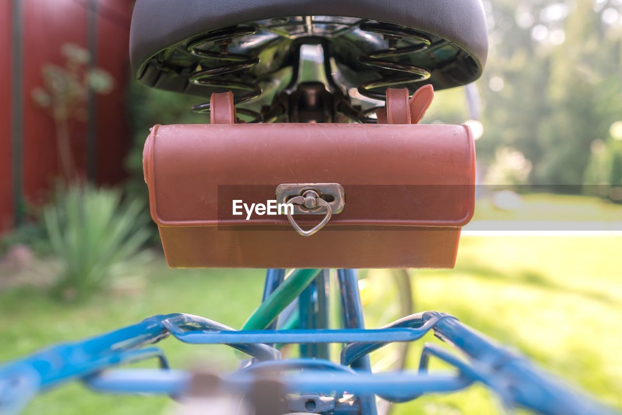 Close-up of purse on bicycle in yard