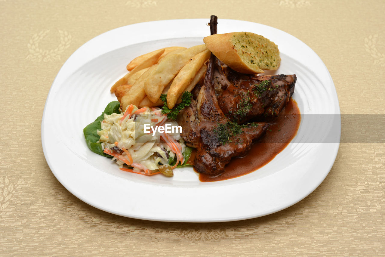 Close-up of meat with french fries in plate