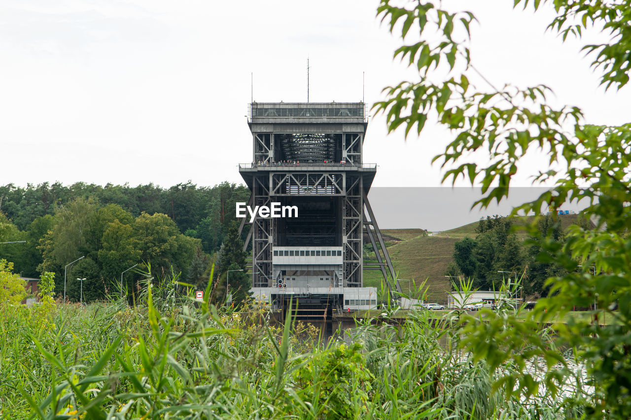 Built structure on field against sky