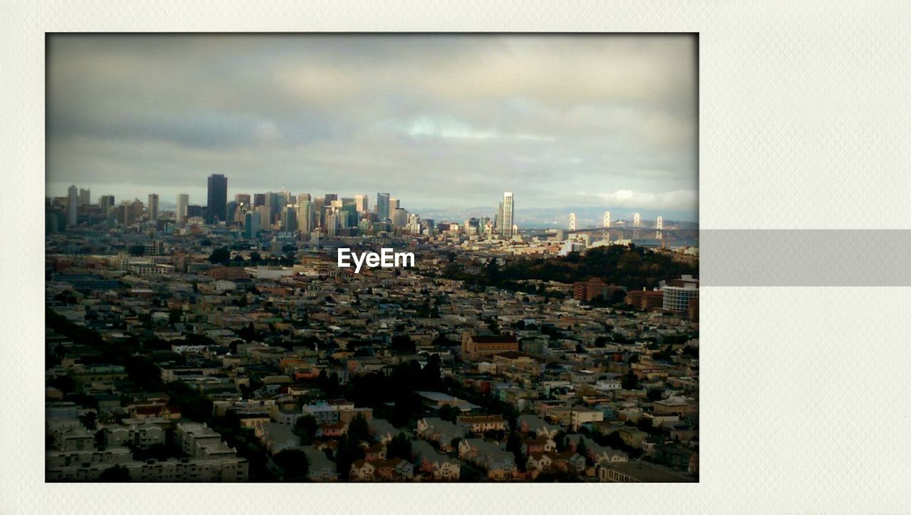 Cityscape against cloudy sky