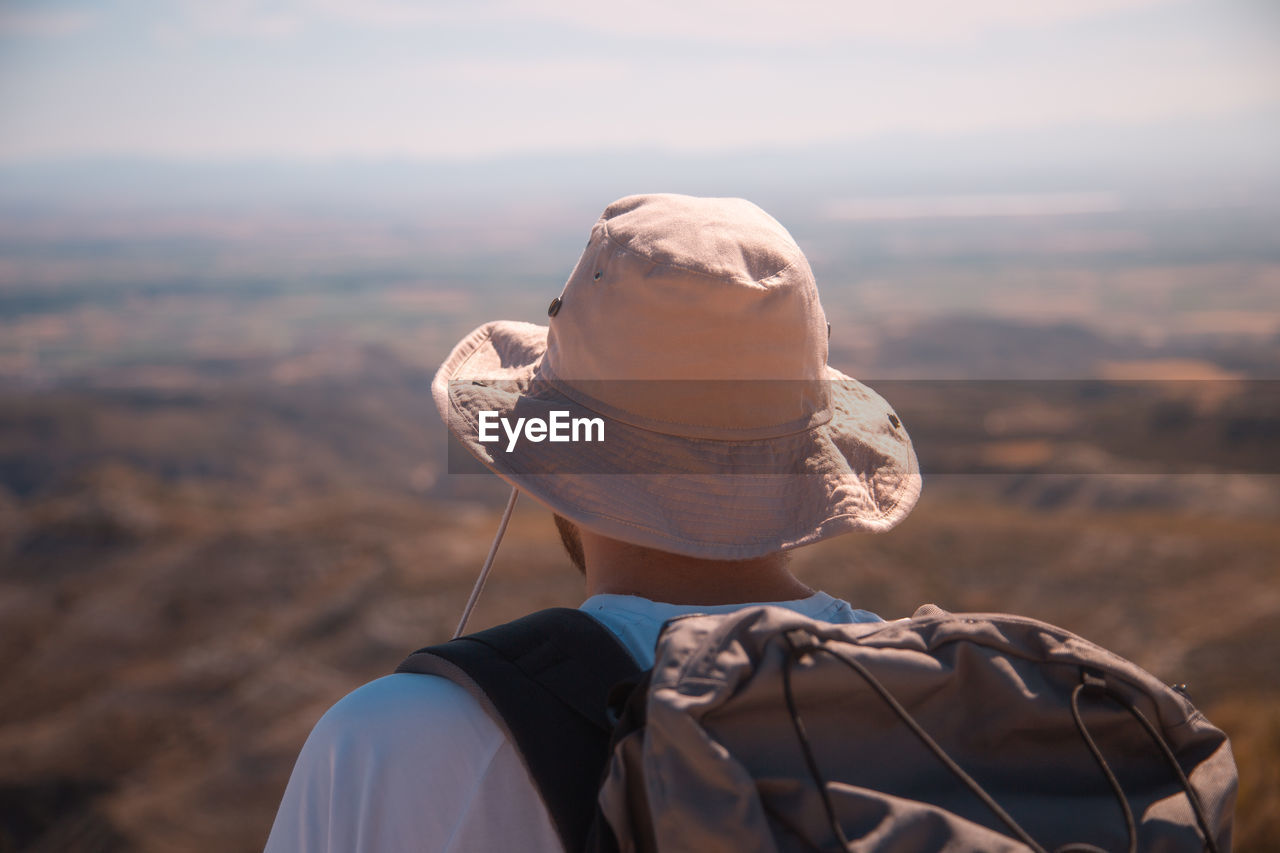 Rear view of man wearing hat against sky