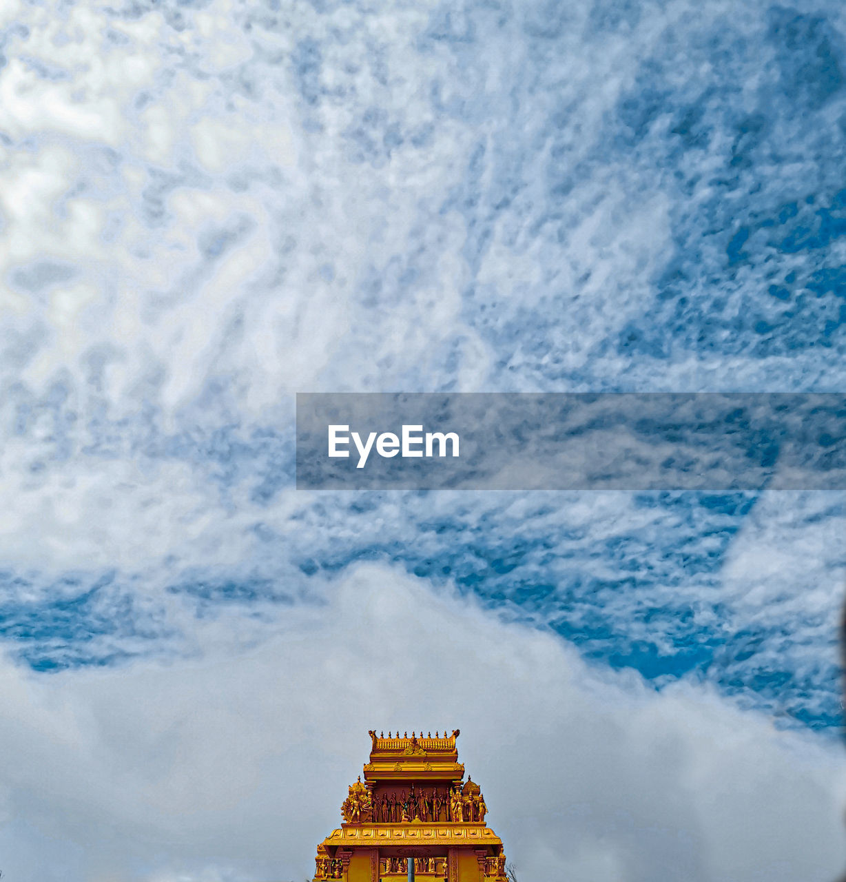 Low angle view of temple against cloudy sky