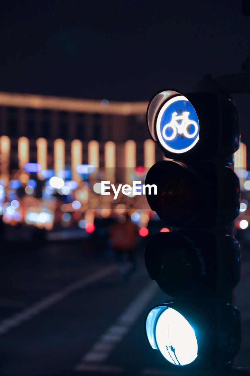 Close-up of illuminated road signal at night