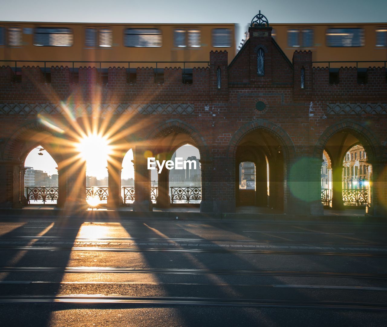 SUNLIGHT STREAMING THROUGH ARCH WINDOW IN CITY