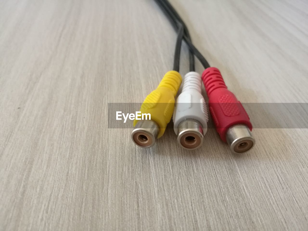 Close-up of colorful rca cables on wooden table