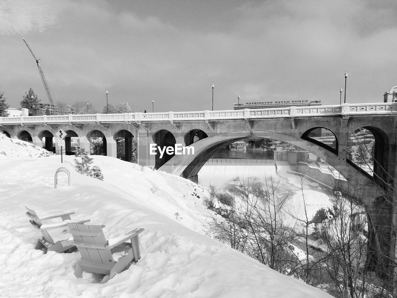 BRIDGE OVER SNOW COVERED LANDSCAPE AGAINST SKY