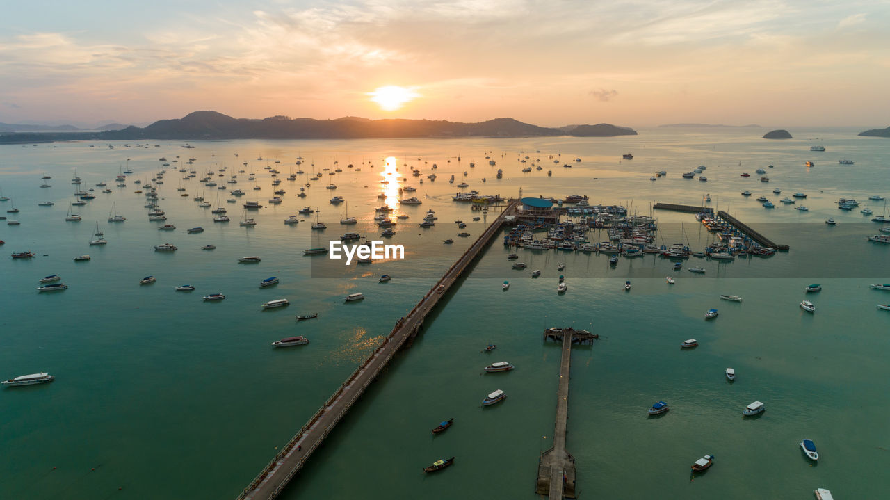 High angle view of boats in sea against sky during sunset