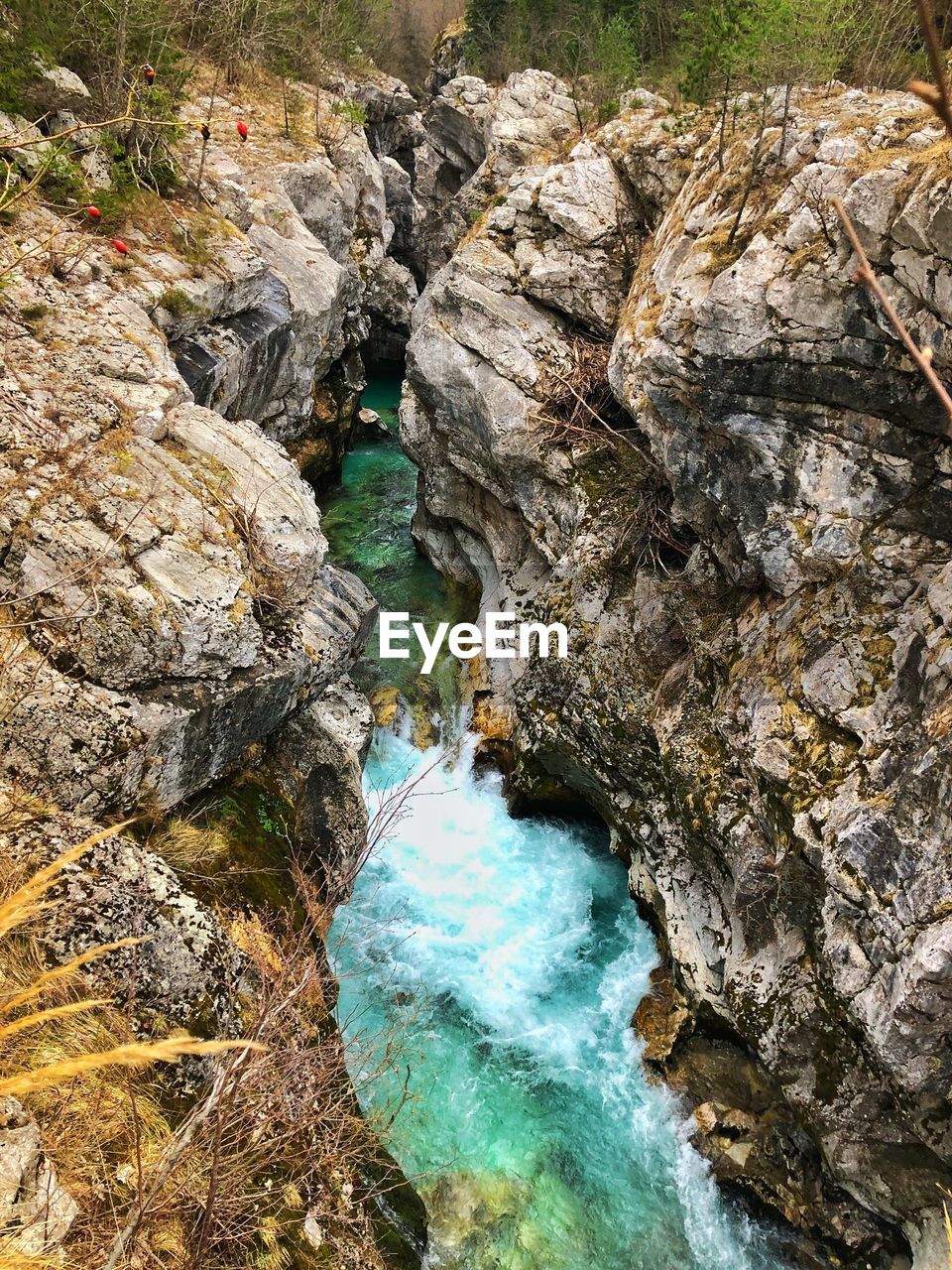 HIGH ANGLE VIEW OF WATER FLOWING OVER ROCKS