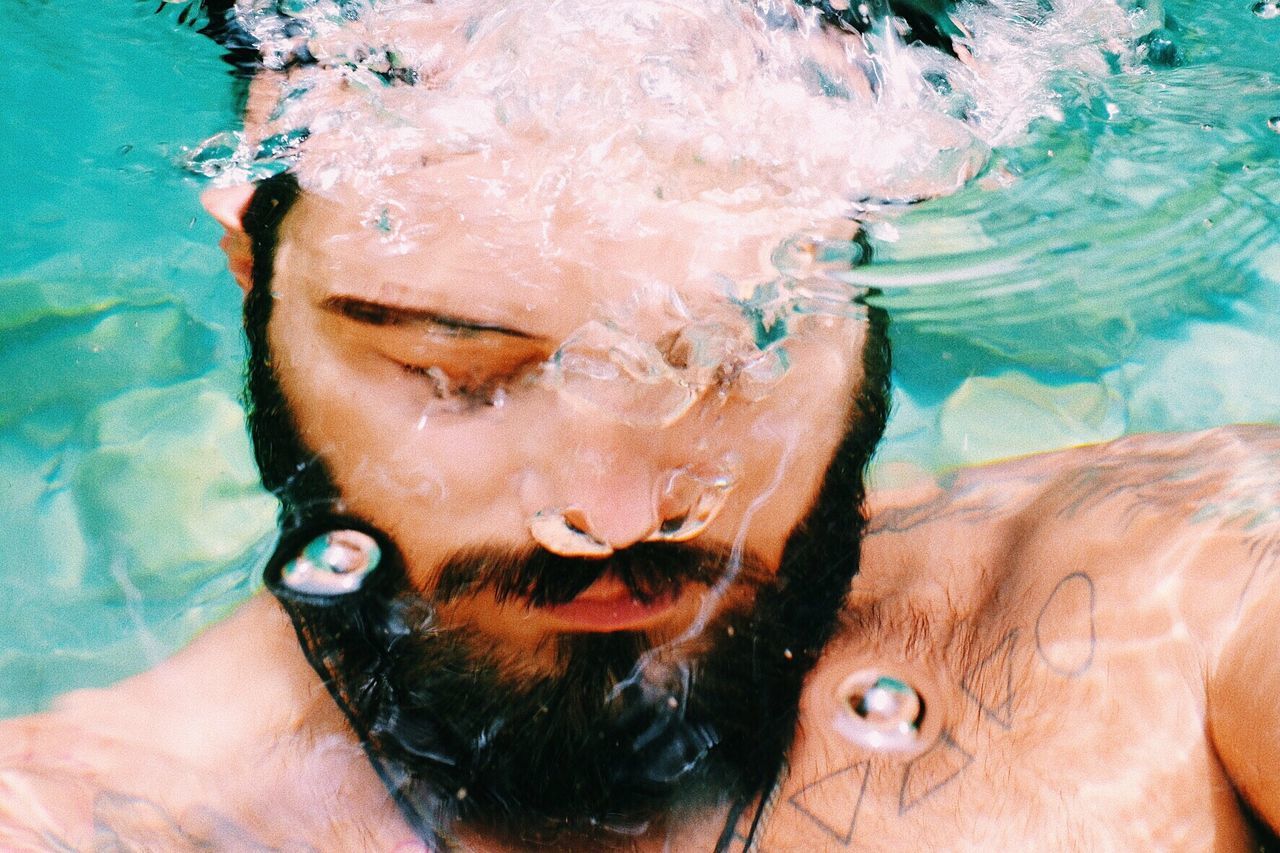 Close-up of man swimming in pool