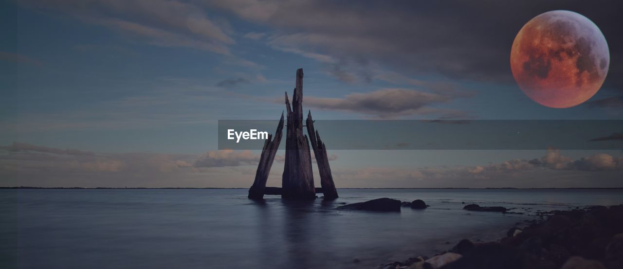 Scenic view of sea against sky at sunset