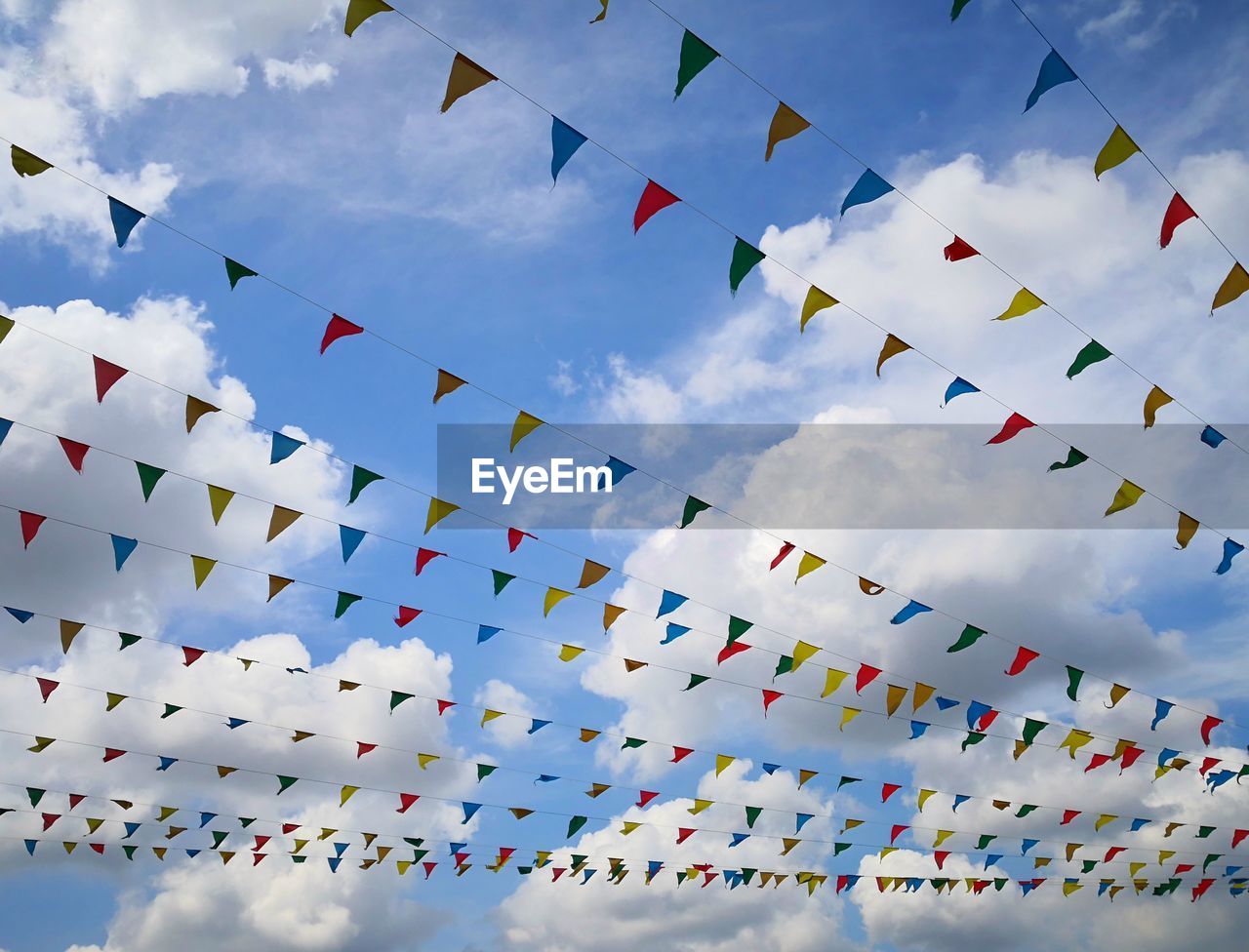 Low angle view of buntings against sky