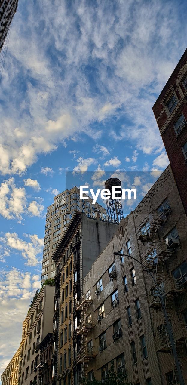 LOW ANGLE VIEW OF APARTMENT BUILDING AGAINST SKY