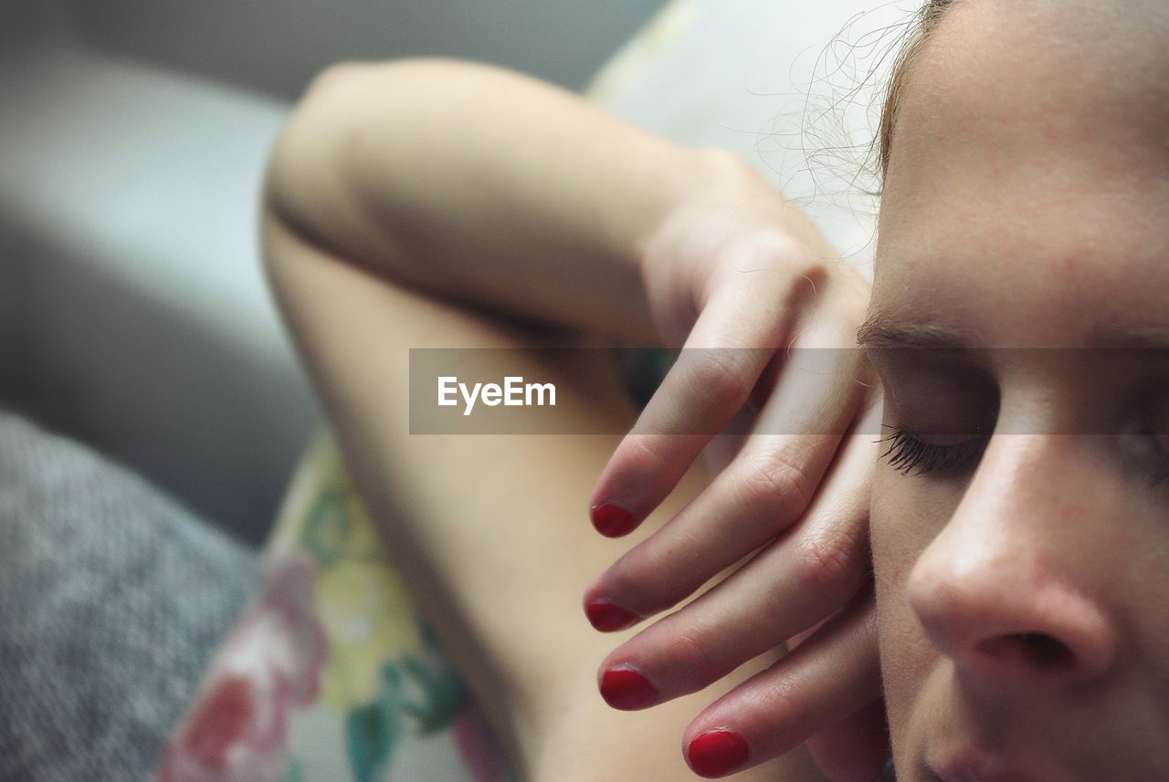 Cropped image of woman sleeping on bed