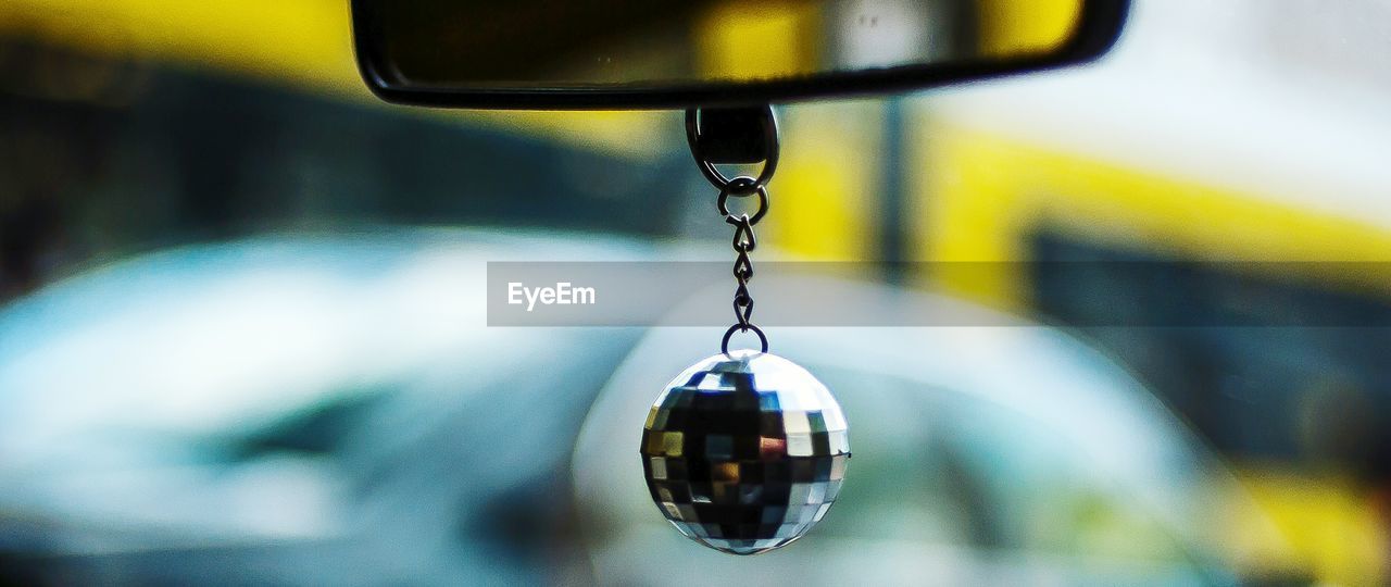 Close-up of disco ball hanging in car