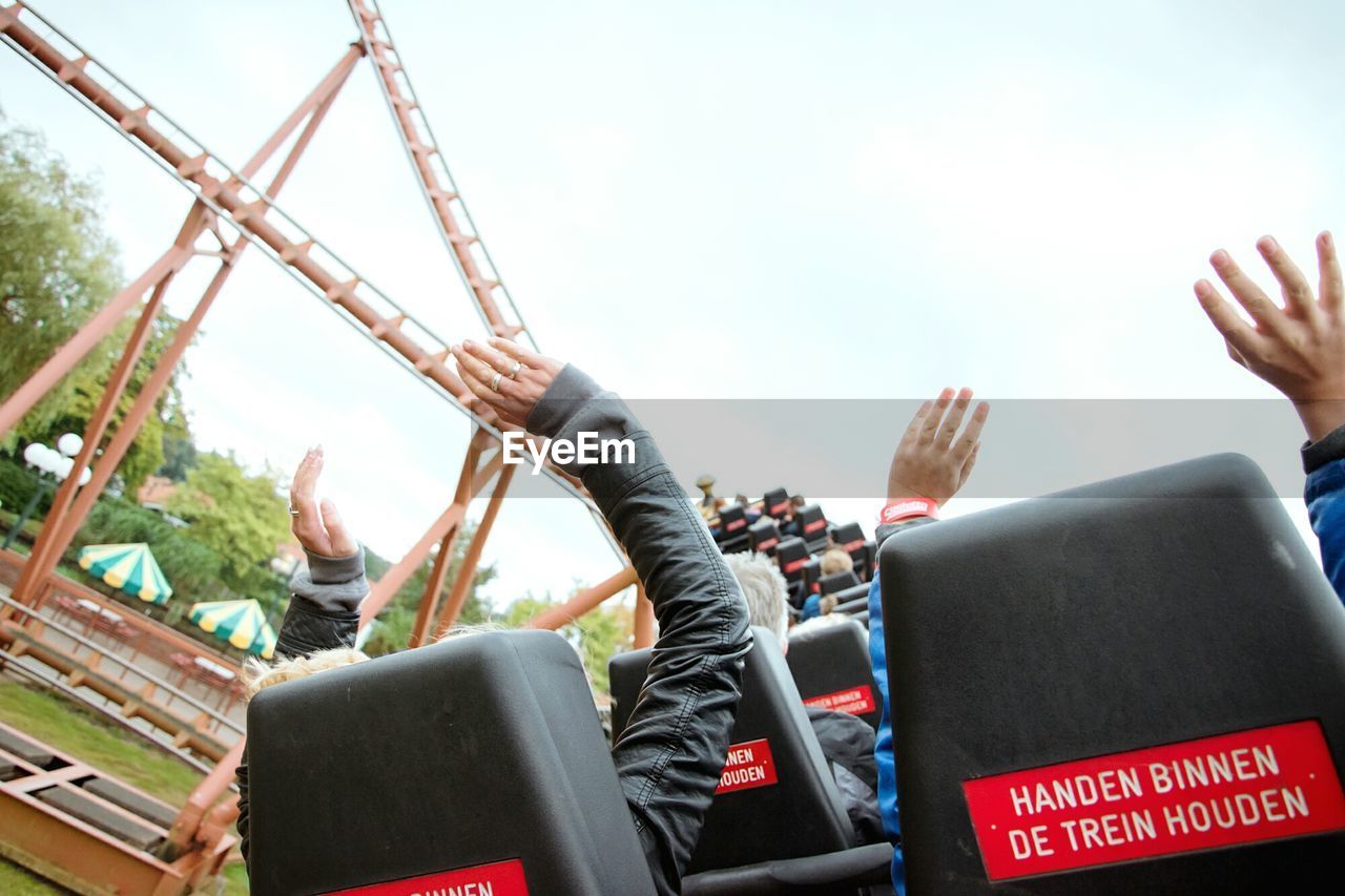 MAN USING SMART PHONE AGAINST SKY