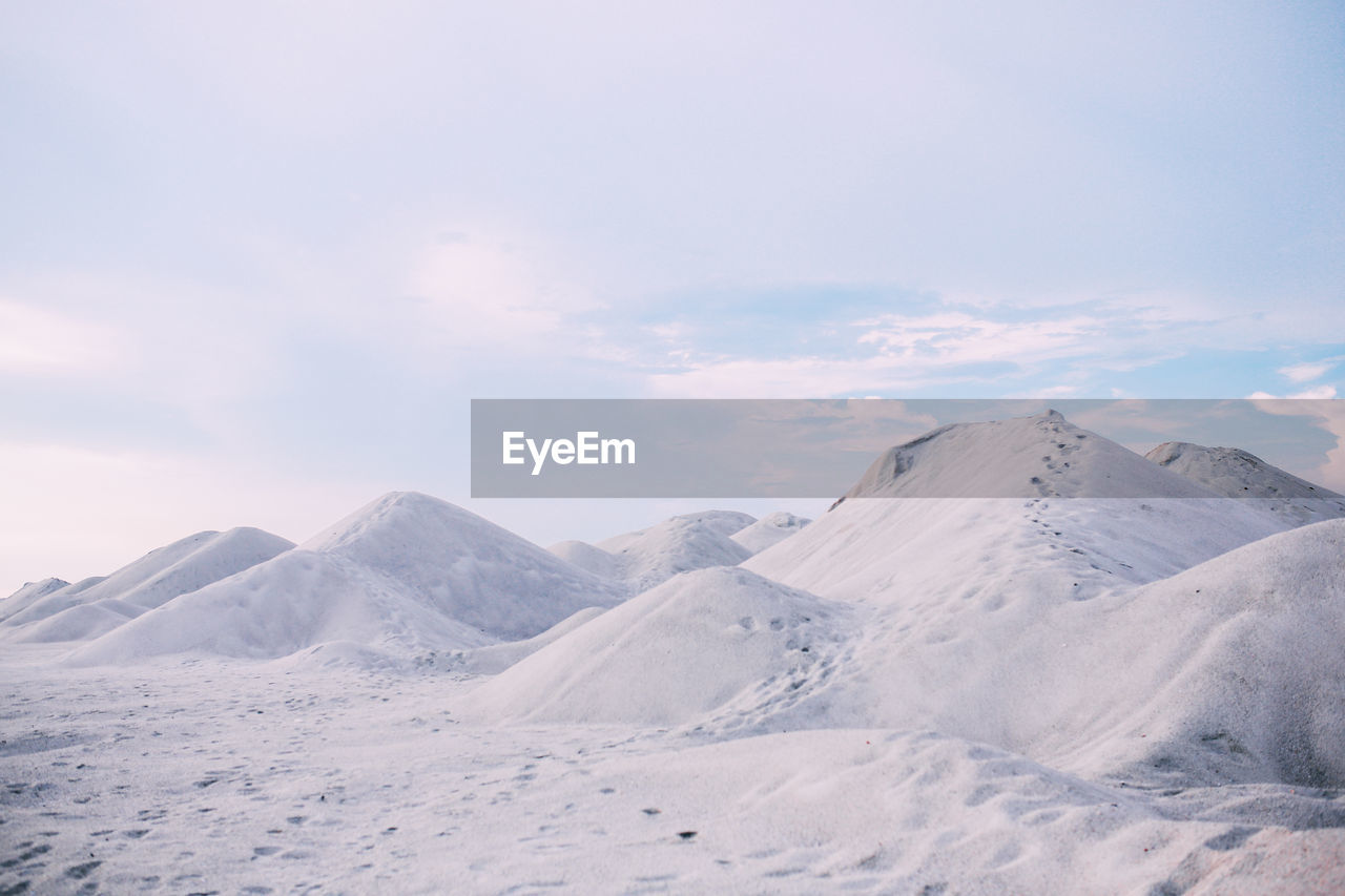 Scenic view of snow covered mountains against sky