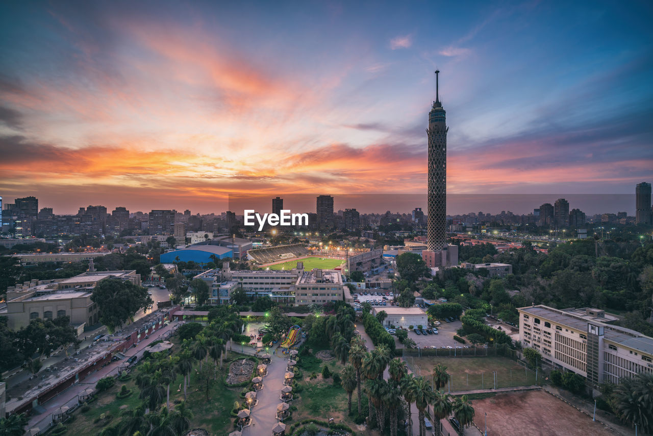 HIGH ANGLE VIEW OF BUILDINGS AT SUNSET