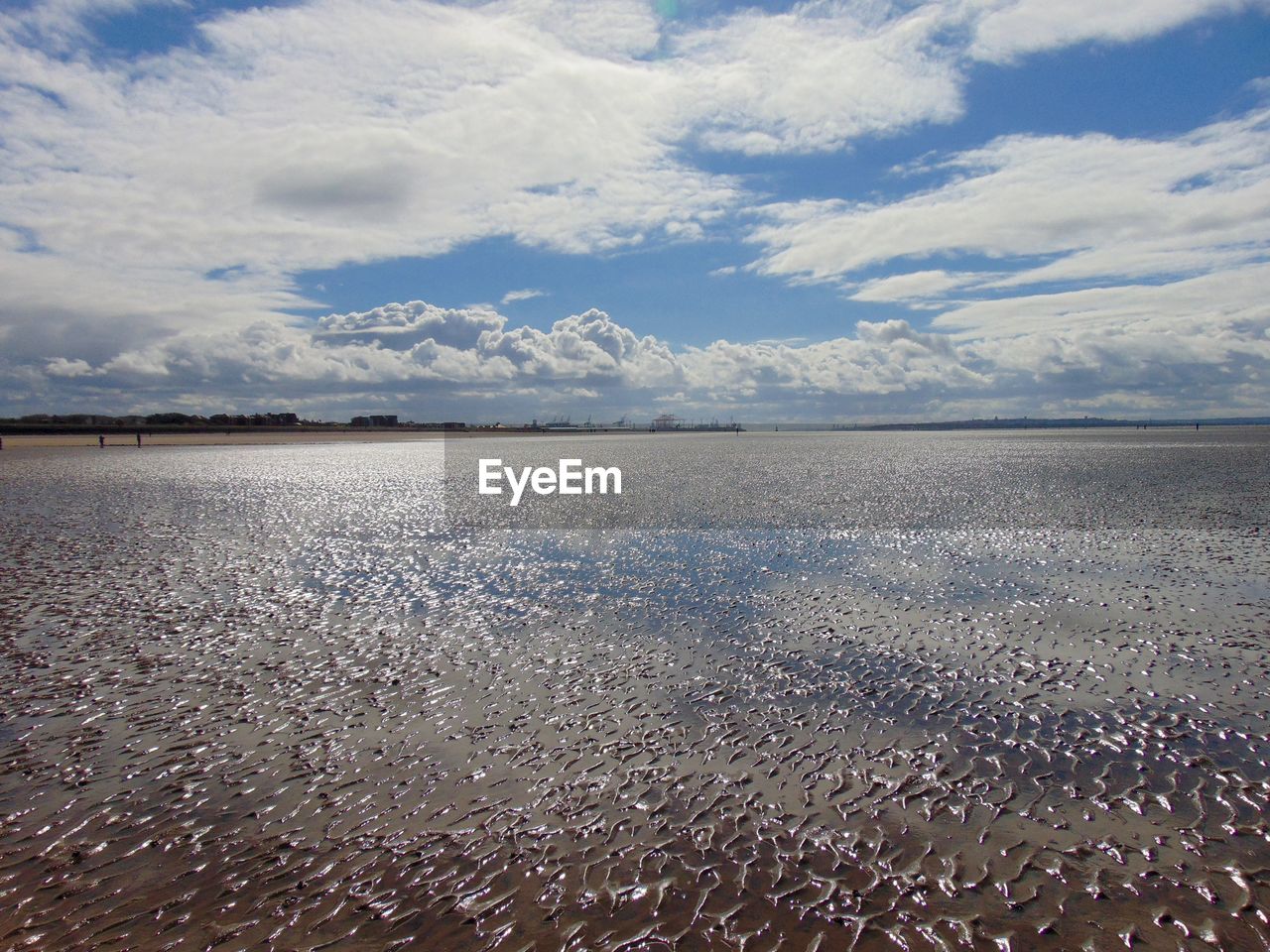 Scenic view of calm sea against cloudy sky