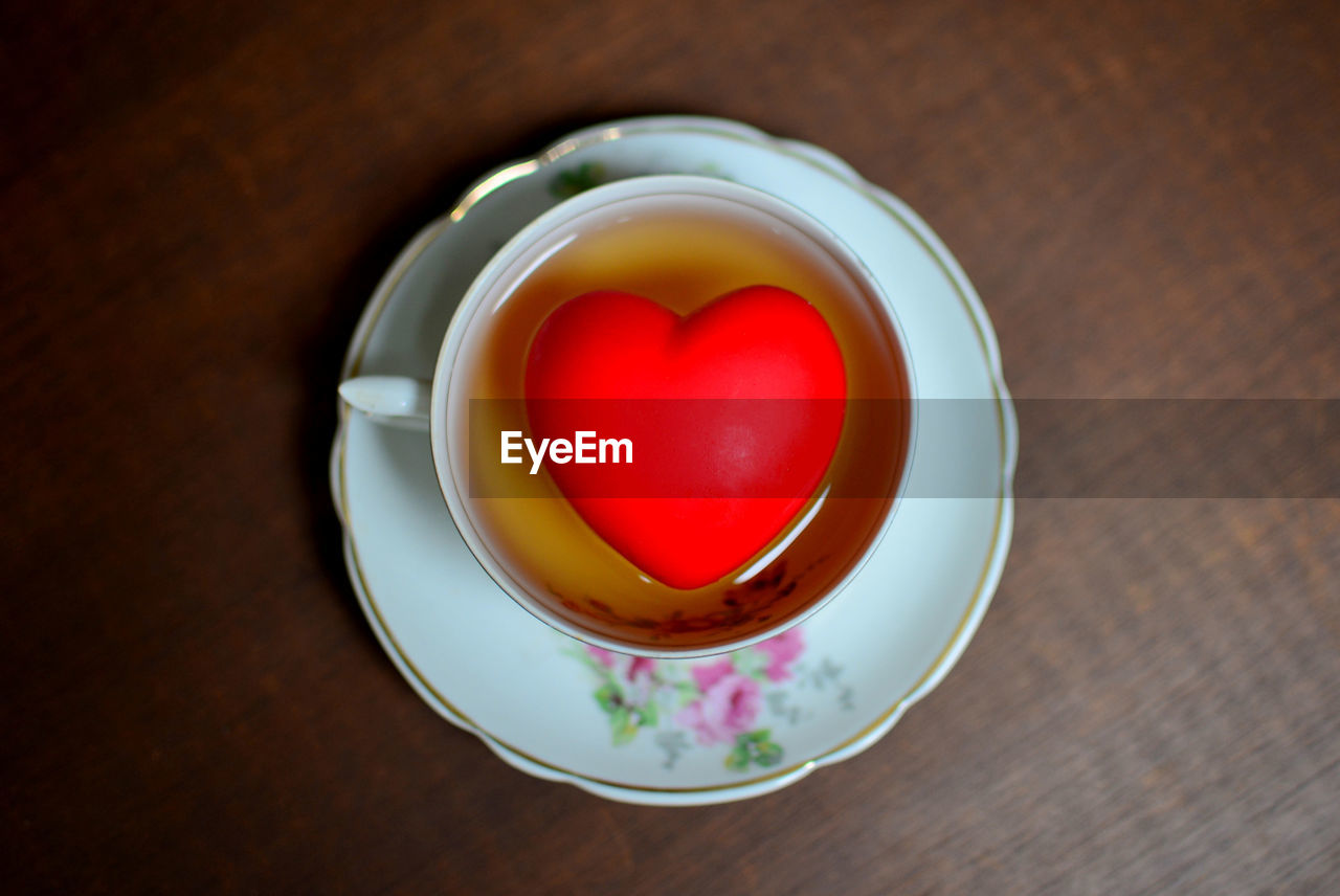 High angle view of tea cup on table with a red heart inside