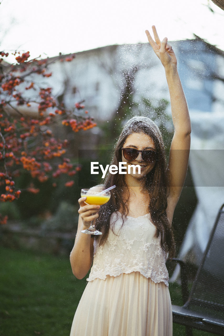 Portrait of young woman with cocktail