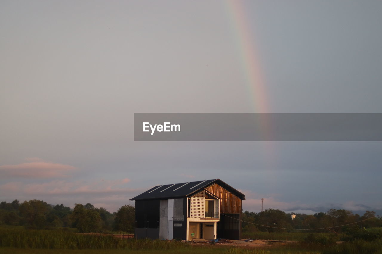 rainbow, sky, architecture, built structure, cloud, building exterior, beauty in nature, landscape, nature, building, house, environment, scenics - nature, rural scene, plant, no people, multi colored, land, tranquility, field, residential district, idyllic, grass, tree, tranquil scene, outdoors, non-urban scene, storm, agricultural building, barn, dramatic sky, day, double rainbow, dusk, farm, rain, natural phenomenon, agriculture