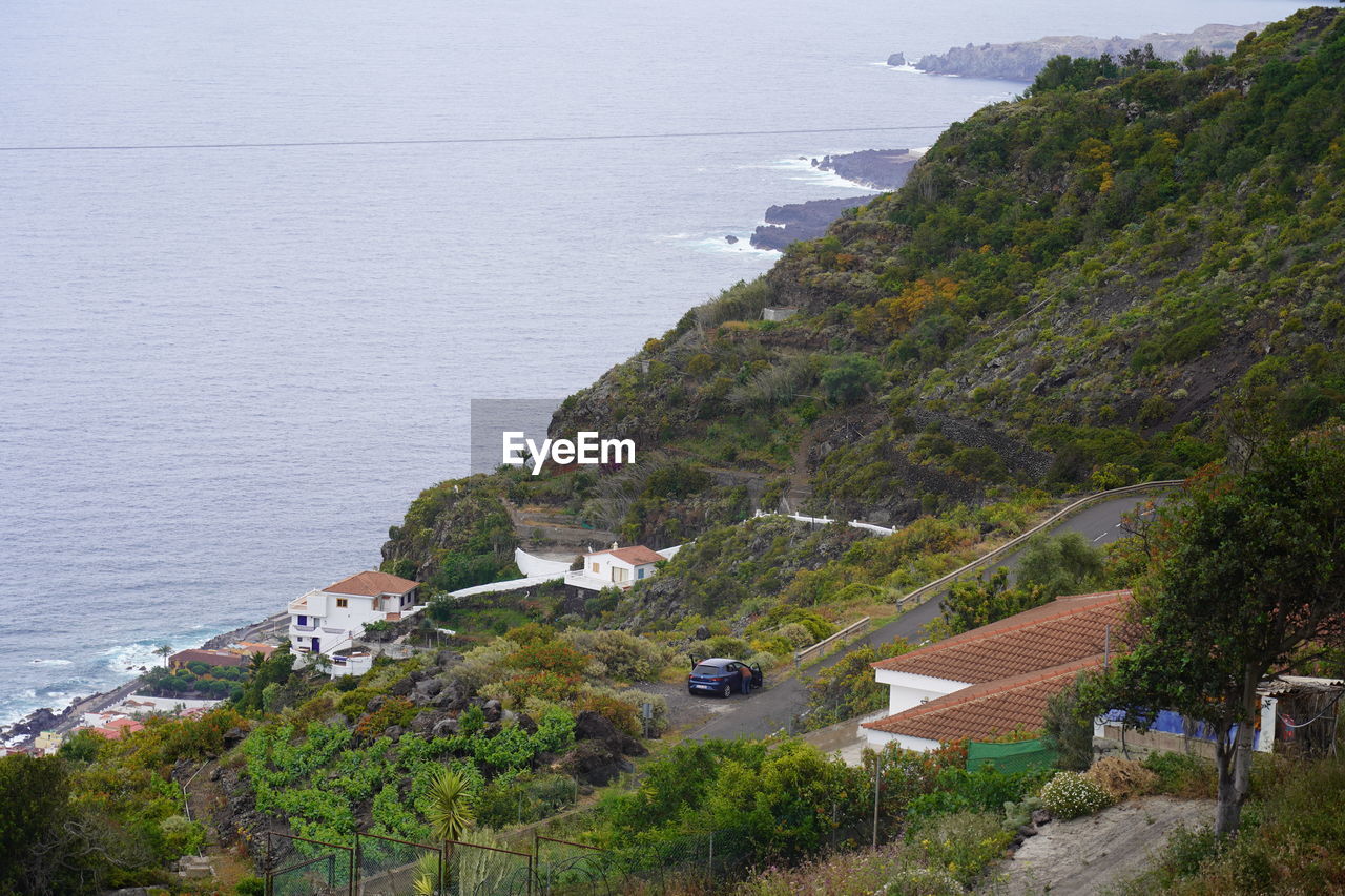 High angle view of houses at coast by sea near garachico, tenerife, canary islands