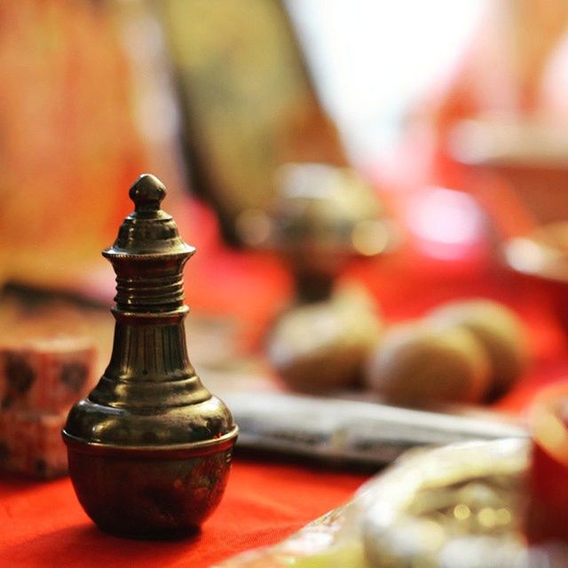 CLOSE-UP OF METALLIC OBJECT ON WOOD