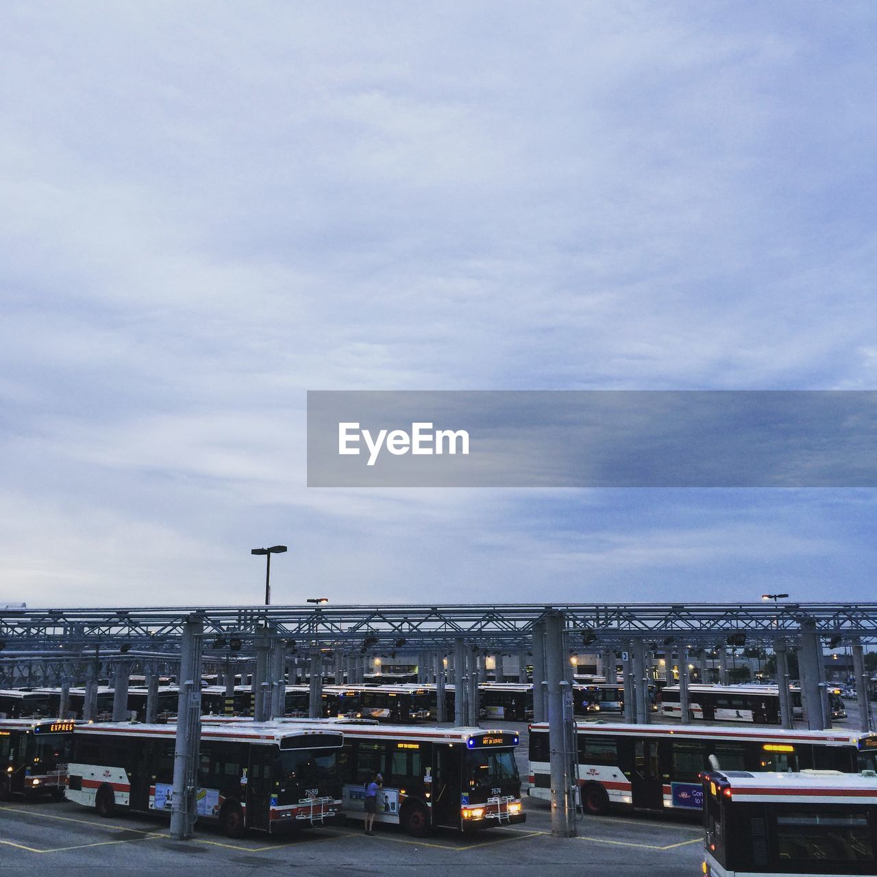 High angle view of buses parked at bus station against sky