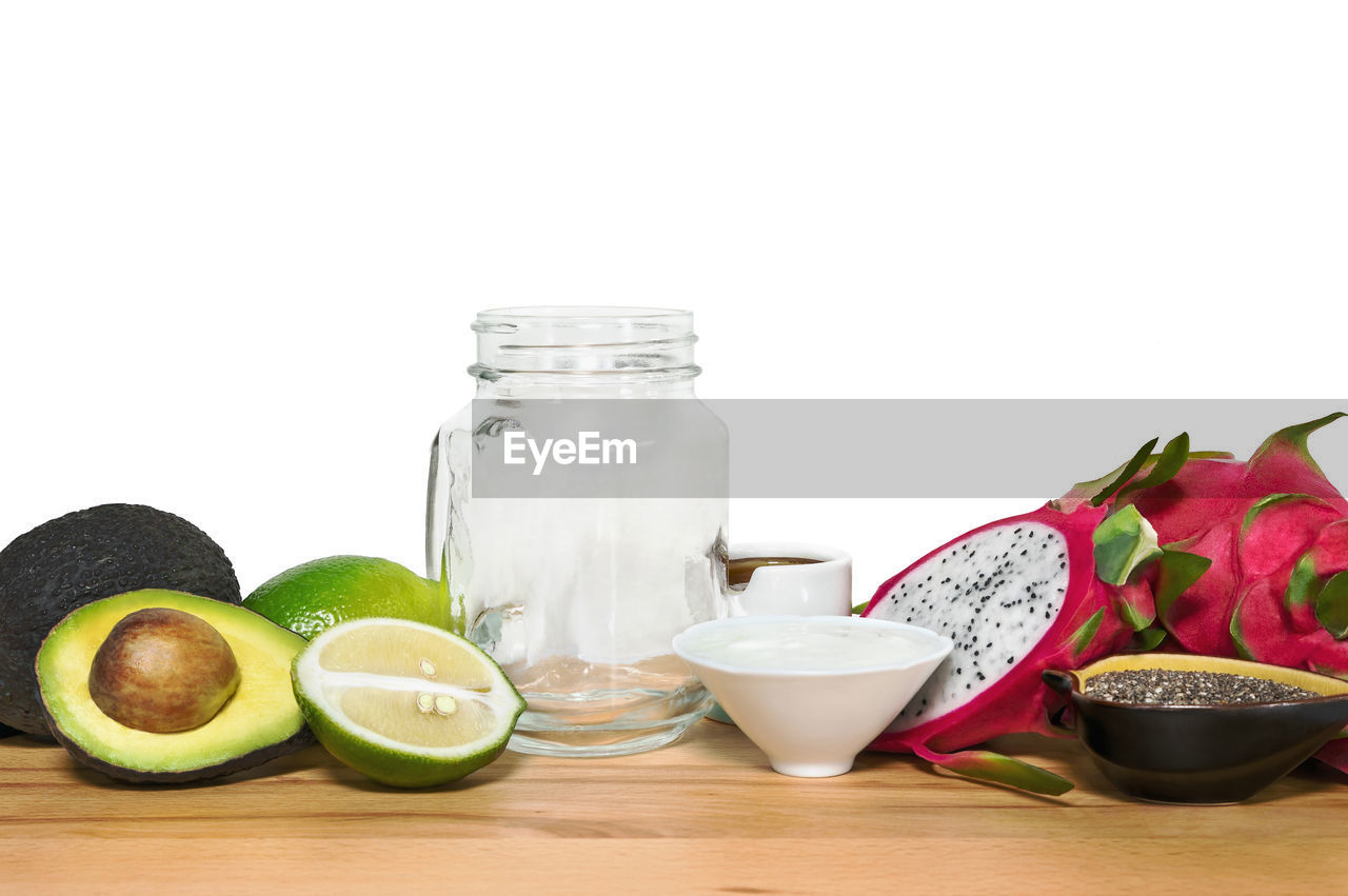 CLOSE-UP OF FRUITS IN JAR ON TABLE