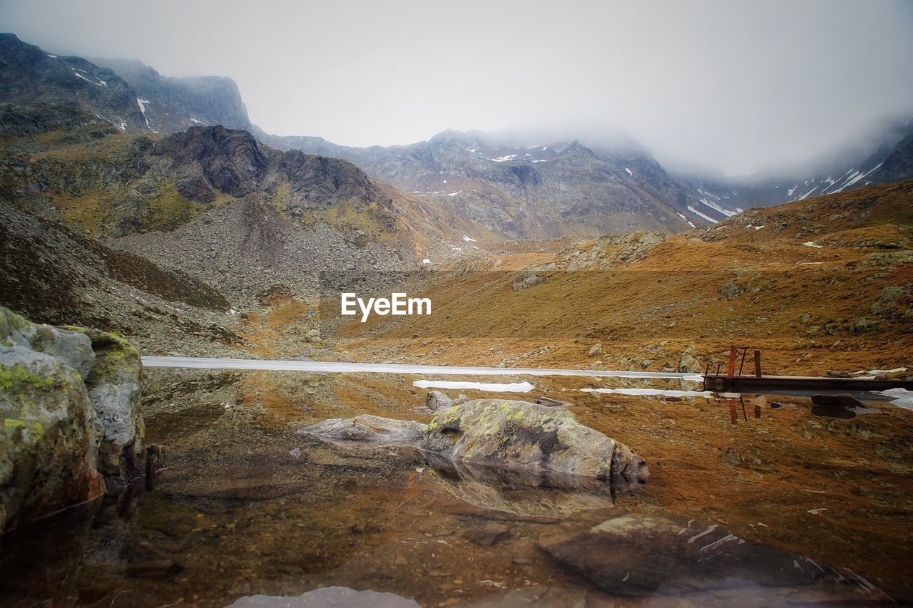 SCENIC VIEW OF LAKE AND MOUNTAINS