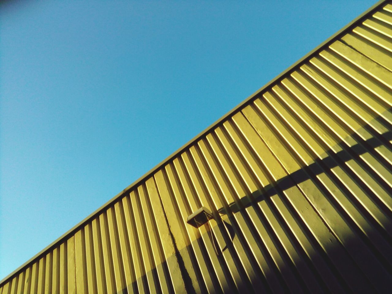 Low angle view of built structure against clear blue sky