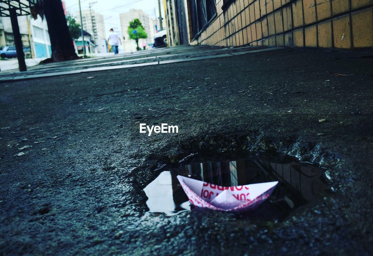 Close-up of paper boat on puddle