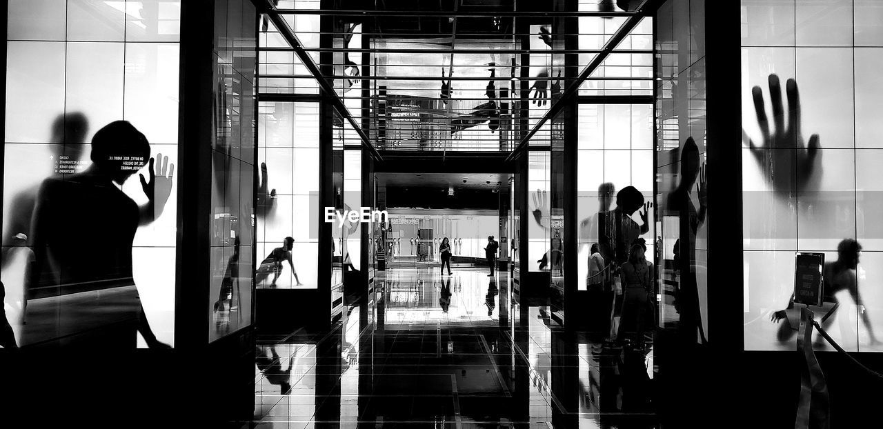 GROUP OF PEOPLE STANDING ON GLASS